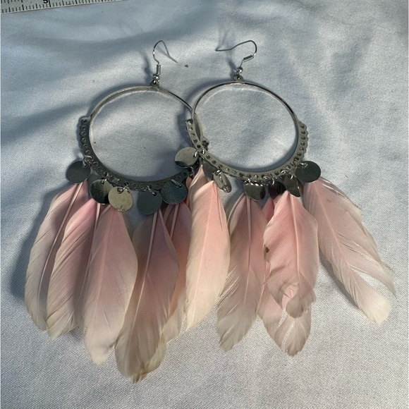 Large silvertone hoop earrings with light pink feathers - Picture 5 of 5
